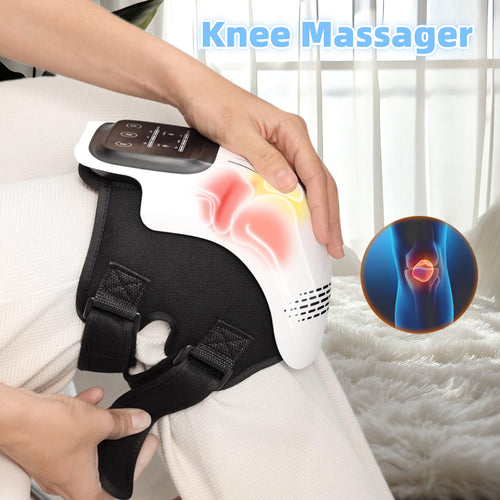Person using a heated knee massager with red light therapy on their knee indoors.